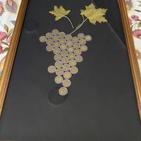 Quadro fatto a forma di uva con monete