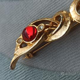 Spilla anni '80 in metallo dorato