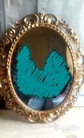 Specchio ovale in legno intagliato foglia d'oro