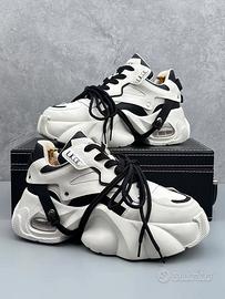 Scarpe fashion da uomo e donna con suola alta
