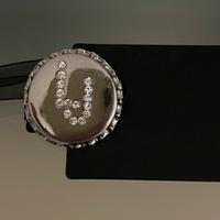 LIU JO spilla strass borsa giacca tappo etichetta