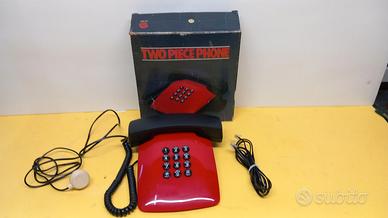 Telefono vintage rosso con cornetta nera, completo