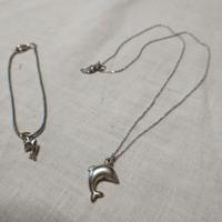 Collana e braccialetto in argento con delfini.