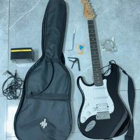 chitarra elettrica nera con amplificatore donner