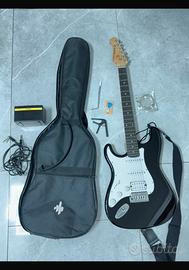 chitarra elettrica nera con amplificatore donner