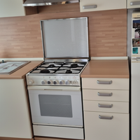 Cucina con frigorifero, forno e piano cottura