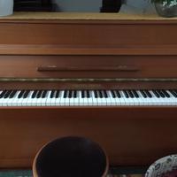 Pianoforte verticale con seduta.