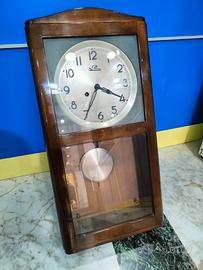 Orologio a pendolo a muro antico vintage 
