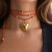 Choker scamosciato arancione con ciondolo sole