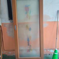 porta scorrevole interno muro di vetro e noce