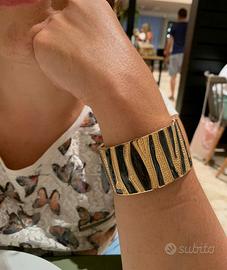 Bracciale a fascia dorato e nero. Nuovo 