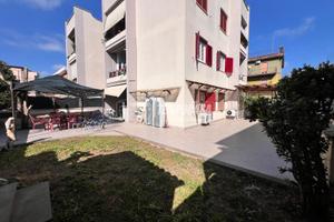 QUADRILOCALE CON GIARDINO PAVIMENTATO E BOX