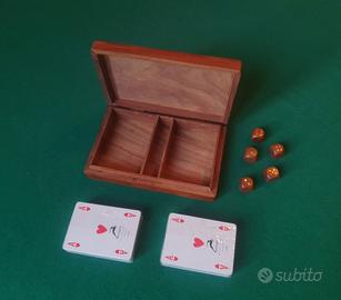 Scatola in legno con carte e dadi.