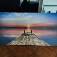 quadro: vista sull'acqua dal pontile al tramonto 