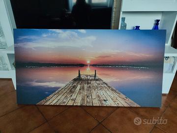 quadro: vista sull'acqua dal pontile al tramonto 