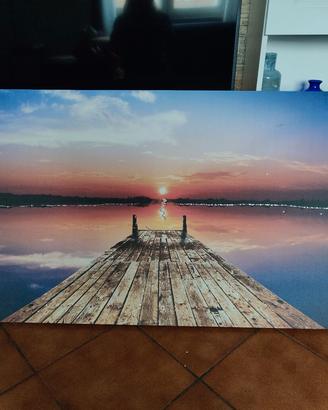 quadro: vista sull'acqua dal pontile al tramonto 