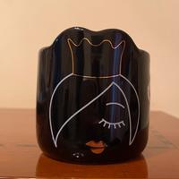 Candela con viso di donna