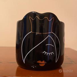 Candela con viso di donna