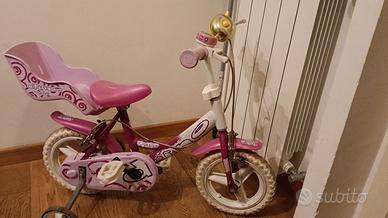 bicicletta rosa con seggiolino bambole