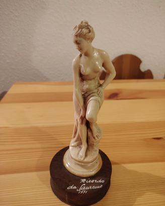 Statuetta in resina marmorizzata e base in legno
A