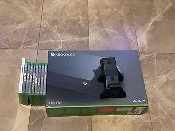 Xbox one x + 9 giochi + base di ricarica