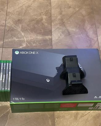 Xbox one x + 9 giochi + base di ricarica