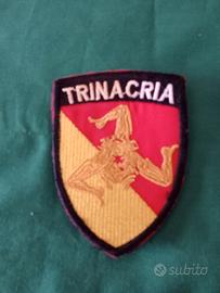 toppa con la scritta trinacria 