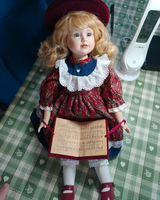 Bambola porcellana bionda cappello rosso spartito 