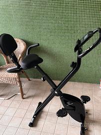 Cyclette nera pieghevole con schienale e maniglie