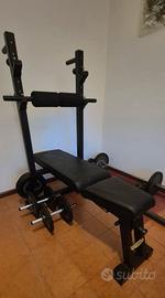 Panca Technogym con bilancieri e pesi