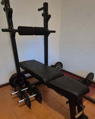 Panca Technogym con bilancieri e pesi