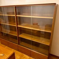 Libreria con ante scorrevoli in vetro e cassetti