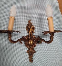 APPLIQUE IN OTTONE CON PUTTO SCOLPITO