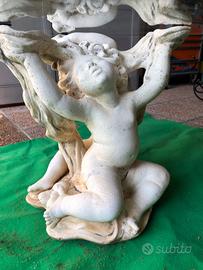 Tavolo in vetro con putti in cemento