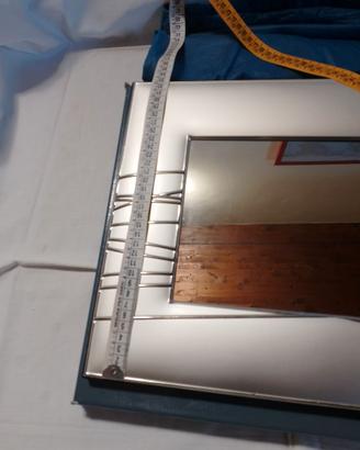 Grande cornice con specchio in lamina di argento