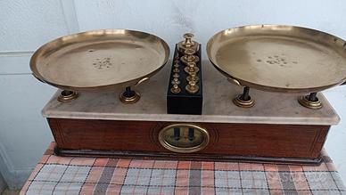 bilancia con piatti e pesi in ottone