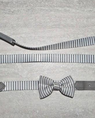 collare e guinzaglio grigi e bianchi con papillon