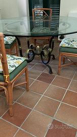 Tavolo in ferro battuto con piano di cristallo.
