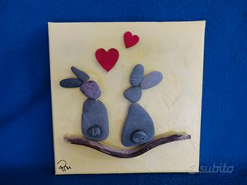 quadretto con conigli in sasso