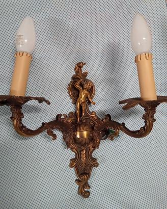 APPLIQUE IN OTTONE CON PUTTO SCOLPITO