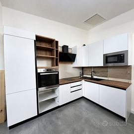 Cucina ad angolo bianca attrezzata con elettrodome