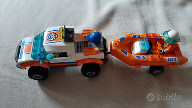 Fuoristrada arancio guardia costiera e gommone