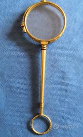 Antico occhialino pieghevole laminato oro