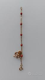 Braccialetto in oro giallo 18K e  corallo rosso
