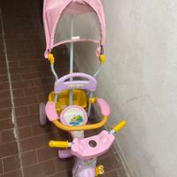 Triciclo rosa con manico