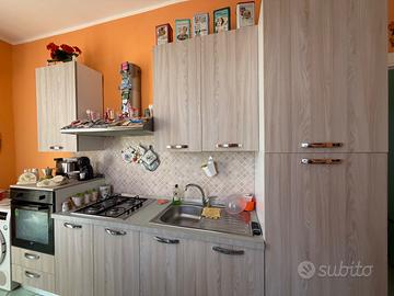 Cucina con elettrodomestici + tavolo e sedie