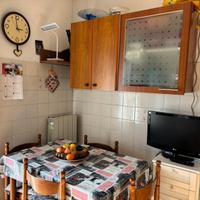 Grande cucina angolare con tavolo e sedie