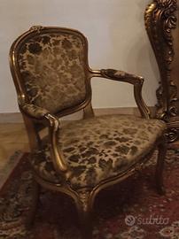 Poltrona barocca in legno intagliato e dorato.