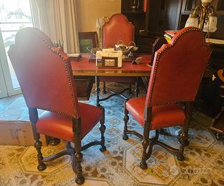 scrivania in legno con sedie e poltrona e libreria