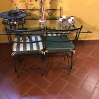 Tavolo in vetro e ferro battuto